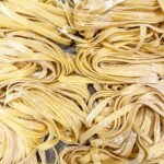 yellow pasta on stainless steel tray